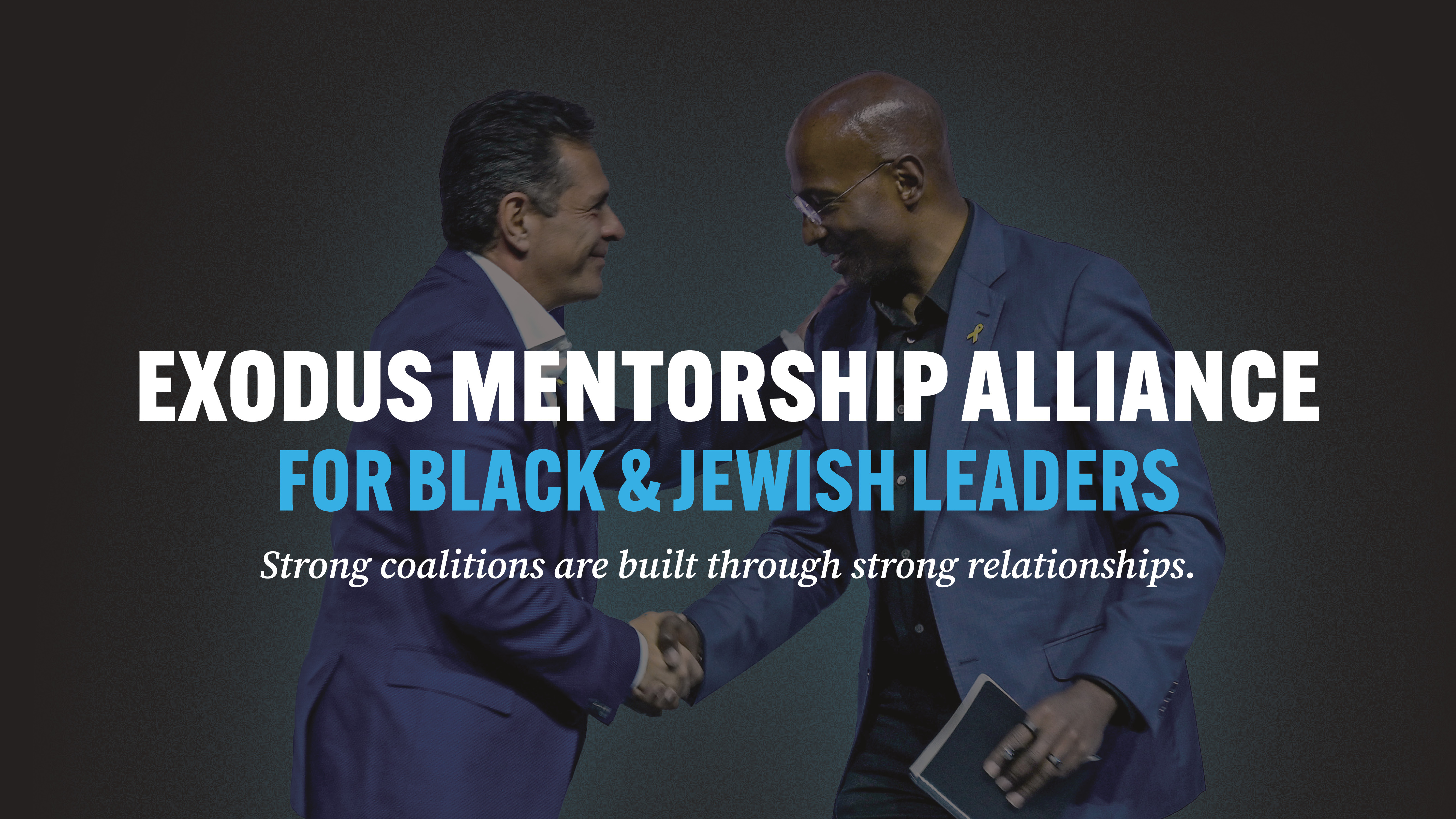 Van Jones and Daniel Lubetzky shaking hands on stage at the Exodus Mentorship Alliance launch